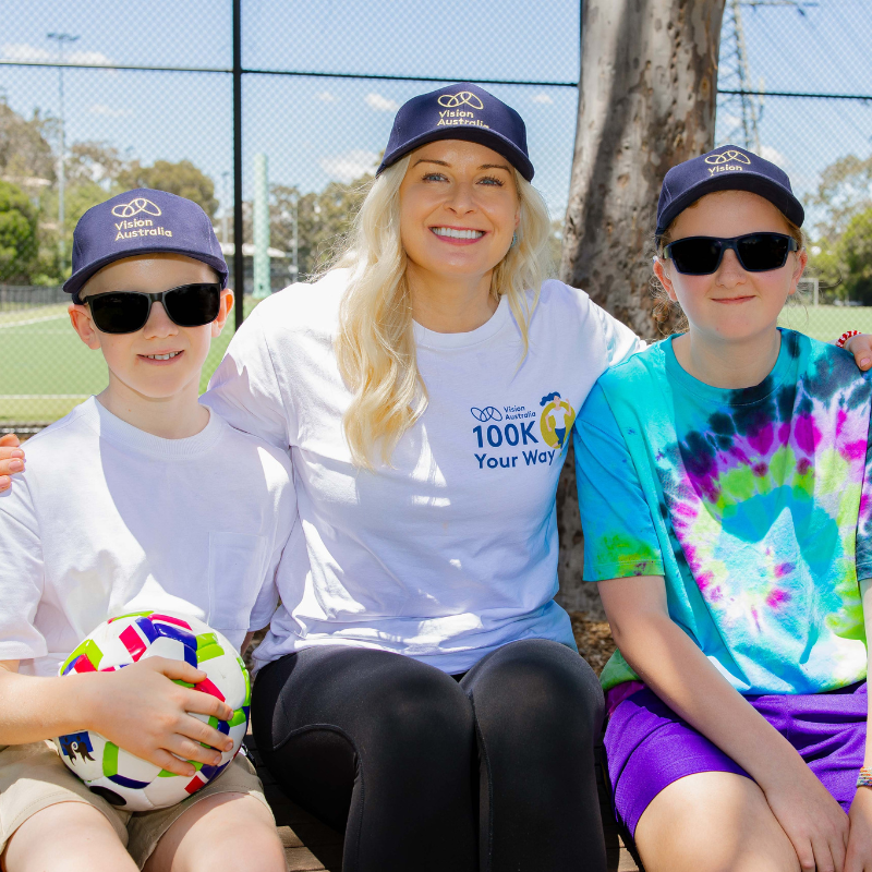 Vision Australia client taking a photo with Paralympian Jess Gallagher and Vision Australia client Alfie.