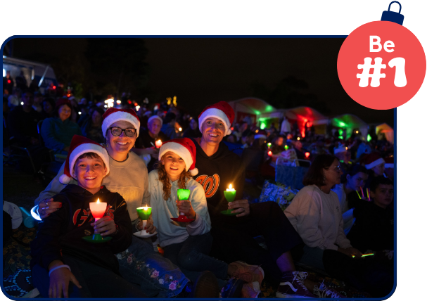 Family holding candles at Carols By Candlelight Family holding candles at Carols By Candlelight