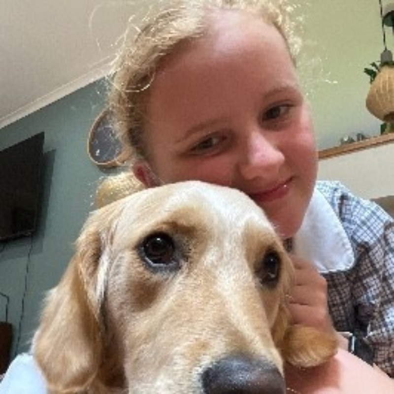 Vision Australia client Indi cuddling her dog