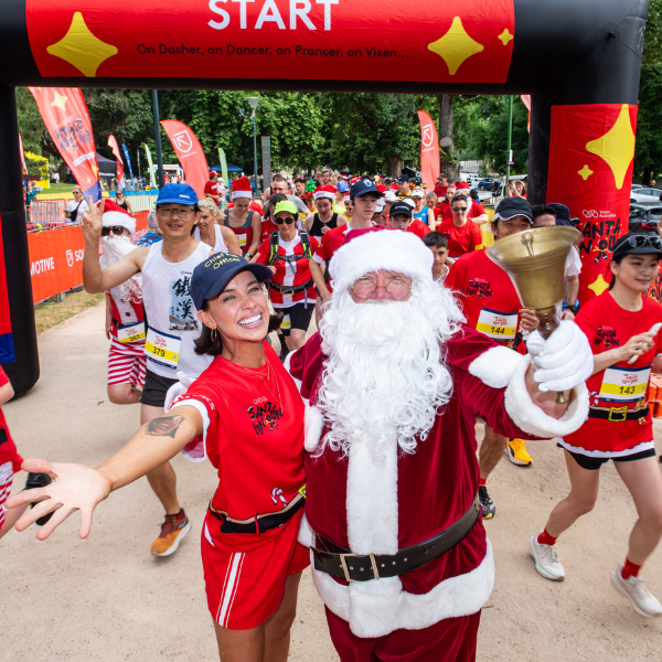 Bonnie Anderson and Santa ringing the bell as the start line of the Santa Fun Run. Bonnie Anderson and Santa ringing the bell as the start line of the Santa Fun Run.