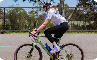 Woman riding a bike wearing Brooks sneakers