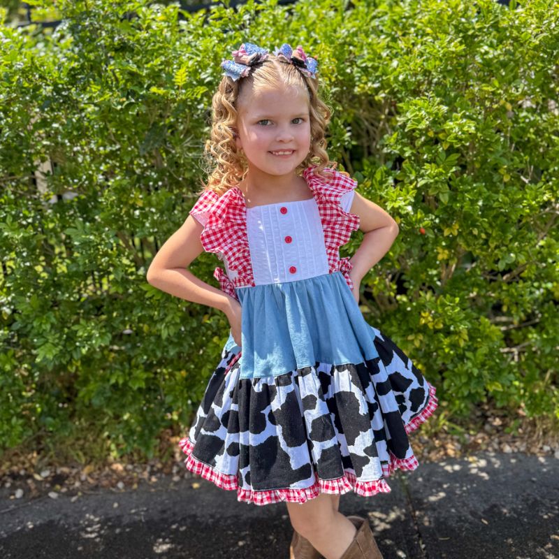 Lucy stands with her hands on her hips, smiling